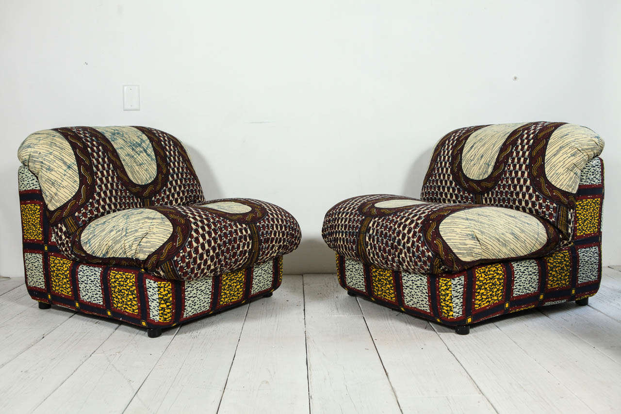 Mod Italian lounge chairs upholstered in contrasting graphic African fabrics. Sold individually.