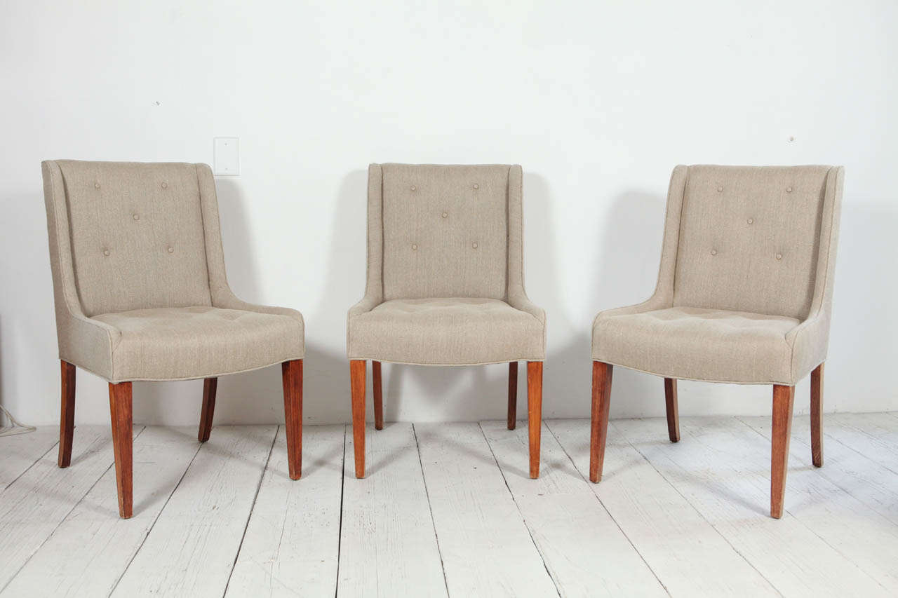 Vintage curved arm dining chairs reupholstered in textured hemp linen.