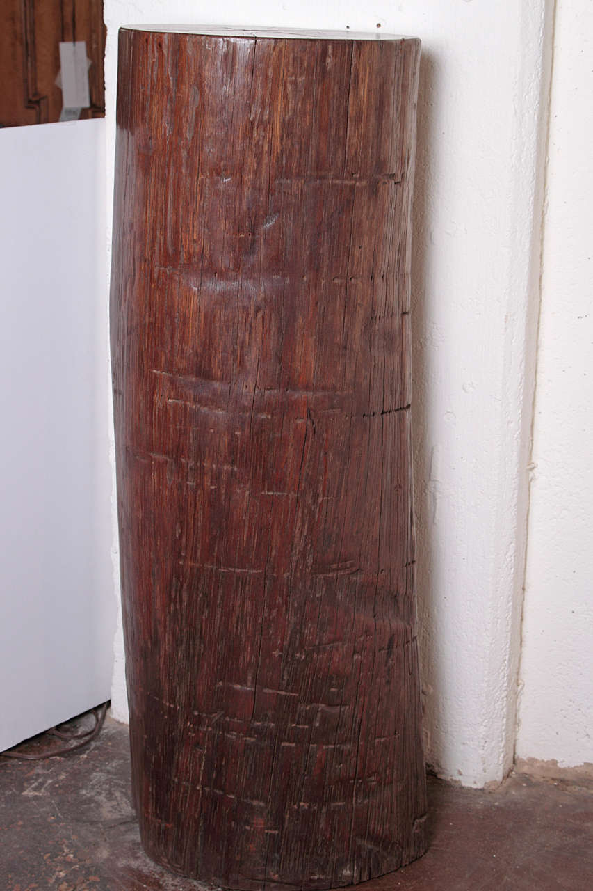 Tall organic iron wood pedestal, 
Organic tree trunk made of ironwood. 

This particular type of Ironwood timber is bug resistant, mildew resistant & durable for weather conditions. Heavy sturdy wood with a deep reddish brown coloration. 