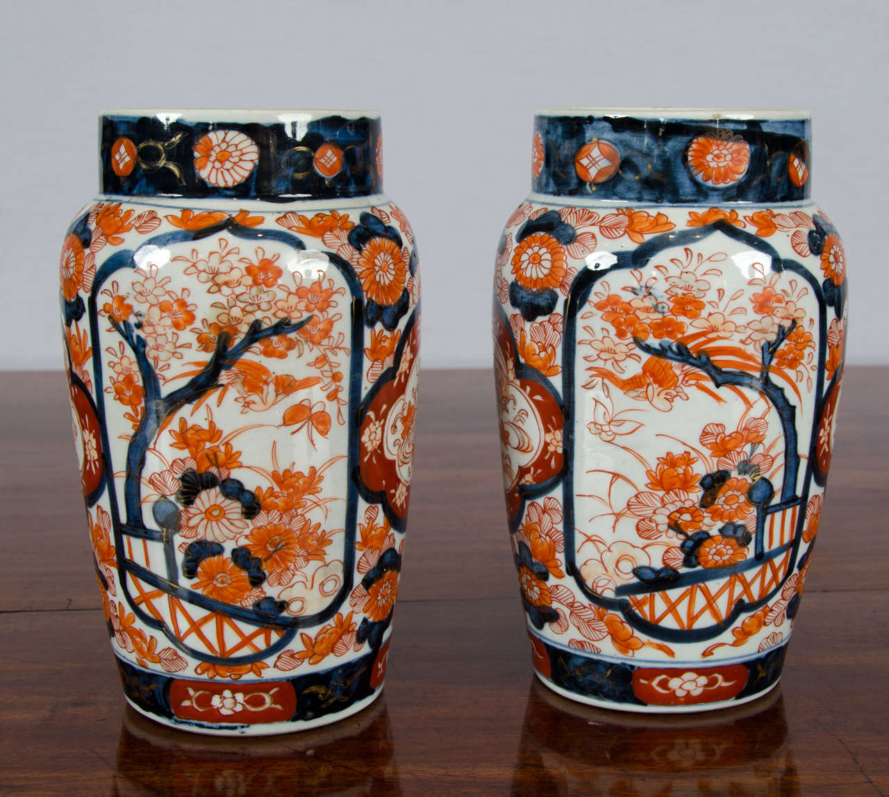 This very attractive pair of Japanese Imari vases have a slightly tapered column shape with wide opening and depict an oriental fenced garden scene. Each vase measures 6 in – 15.2 cm diameter and 9 ¾ in – 25 cm in height.