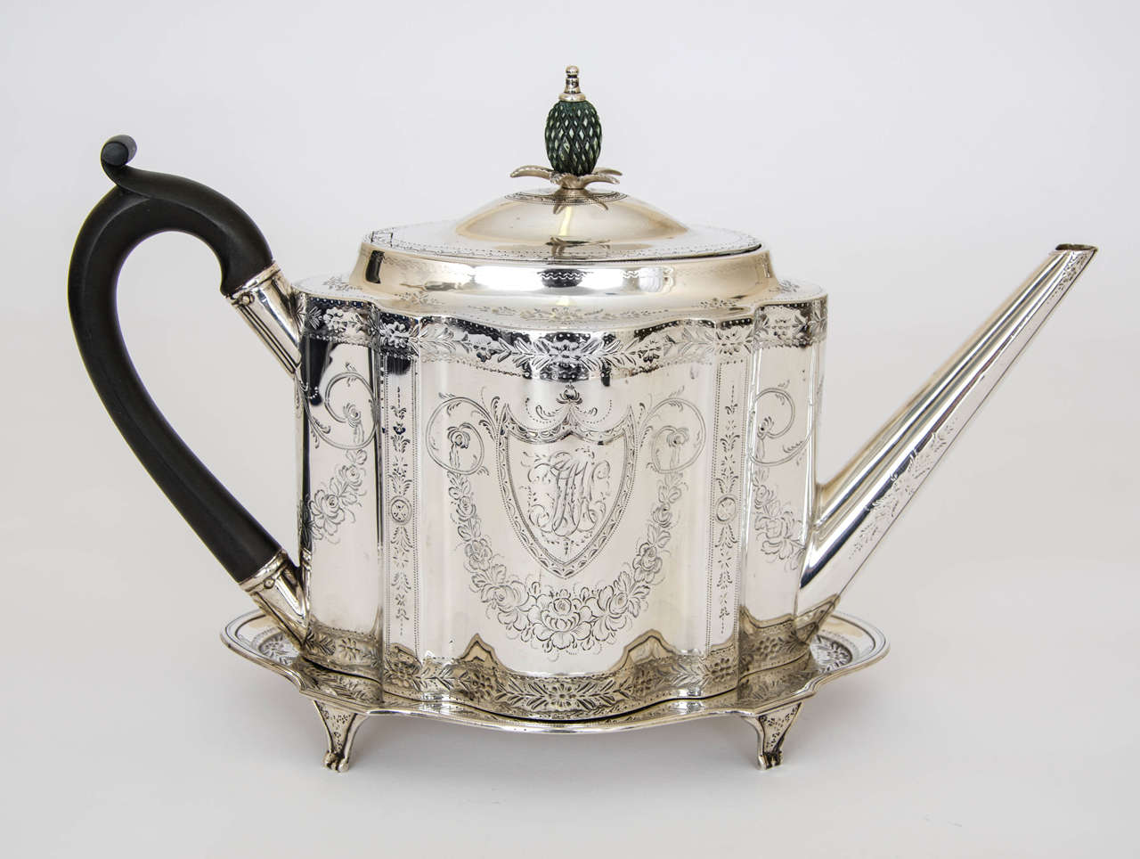 A superb George III antique silver tea pot and stand, the teapot is of serpentine shape with wonderful bright –cut engraving of flowers and foliage, with a cartouche on either side enclosing initials. The bright –cut engraving is repeated on the