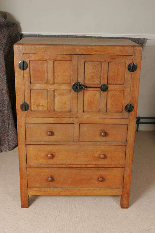 An early Oak Robert "Mouseman" Thompson Tallboy.
Rounded edge, the sides and two front doors set with inset panels of figured oak.
Two short and two long drawers.
Carved inset mouse.
Original wrought iron latch and hinges.
English
Circa