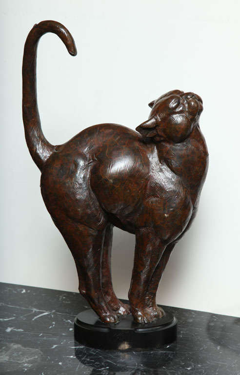 Dan Ostermiller (American, born 1956).
Bronze figure of a cat modeled in a stretching pose, edition 28/30, dated 95, on a marble base. 
Height: 20 1/2 inches.