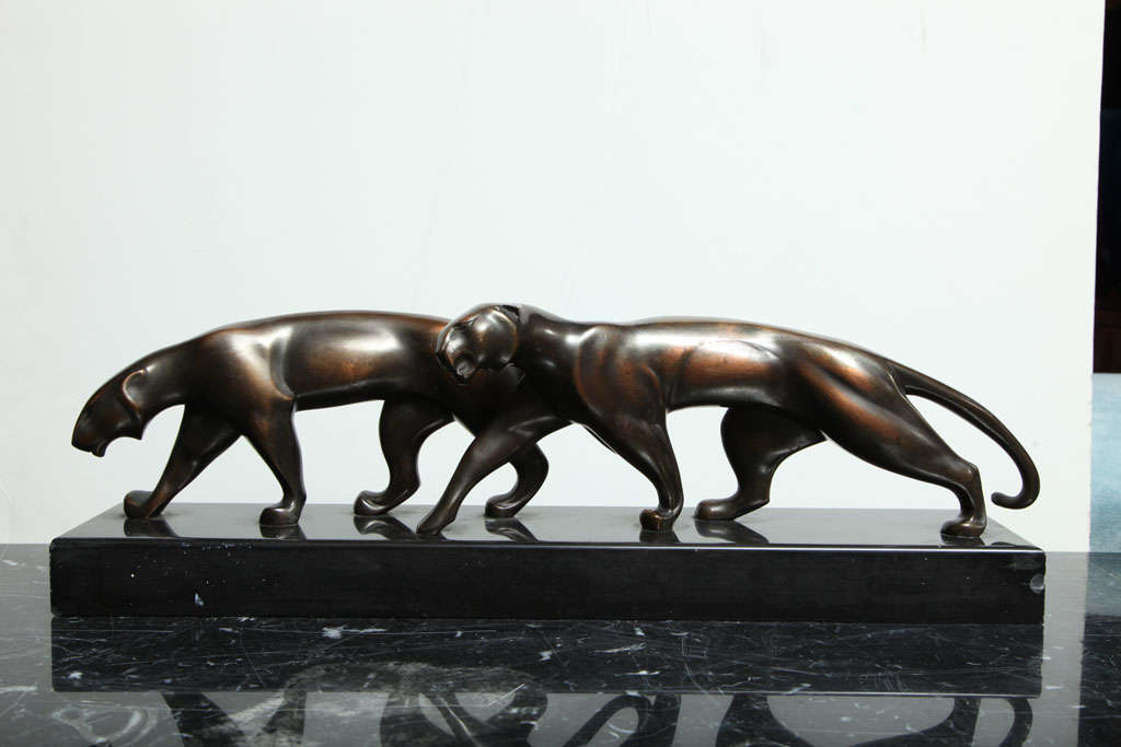 Michel DECOUX (1837 - 1924) 
Two Panthers
Patinated bronze on black marble base
Height.: 6 in. (16 cm) , Length.: 20 in. (51 cm) , Depth: 4 in. (10 cm)