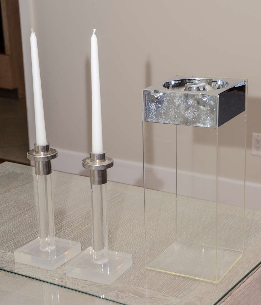 Standing ashtray with removable metal tray  on lucite frame. Also pair of  lucite/metal  candlesticks. Candlesticks height is 10 inches. Ashtray height is 15 inches. Each item can also be purchased separately. Call for price.