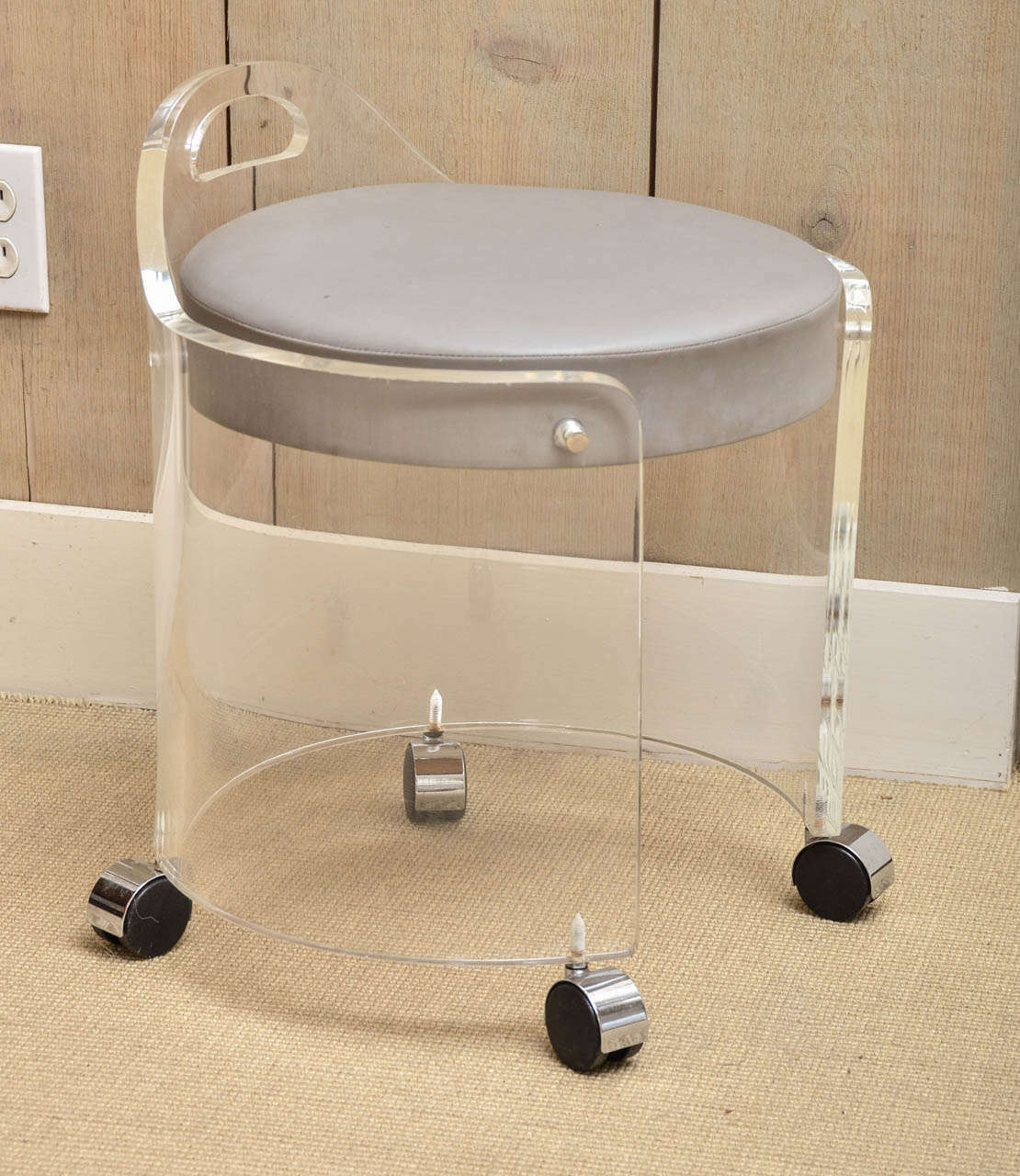 Attractive Lucite vanity stool designed by Charles Hollis Jones. The stool is on casters and has grey leather upholstery