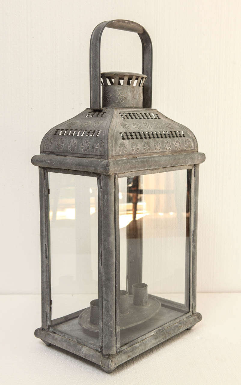 Vintage metal candle lantern with candle holder.  Hinged glass door onone side, and candleholder is removable for installing candler. For the table top.  Holds 3 candles. Ready for your custom wiring, if desired.