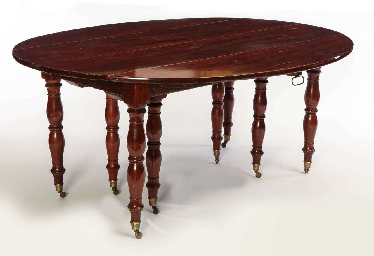 A fine French 18th century brass-mounted mahogany extending drop-leaf dining table with Jacob style legs, with two leaves.

73 cm high, 165 cm. Diameter, each leaf 62 cm. Wide.

With a further possibility of other extending leaves.