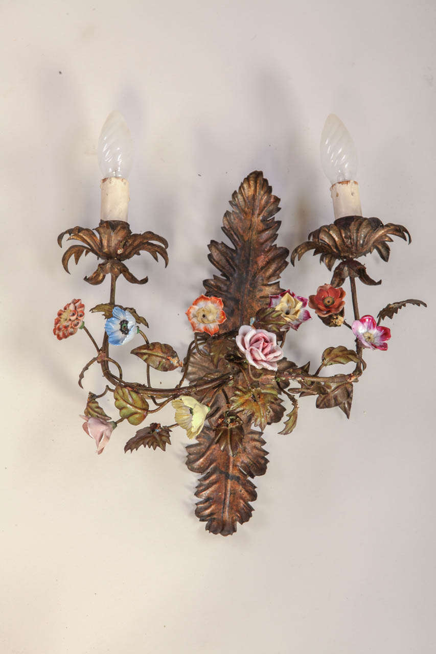 A fine pair of 19th century wall light with two gilt metal scroll mounts issuing branches with Meissen porcelain flowers supporting two sconces.