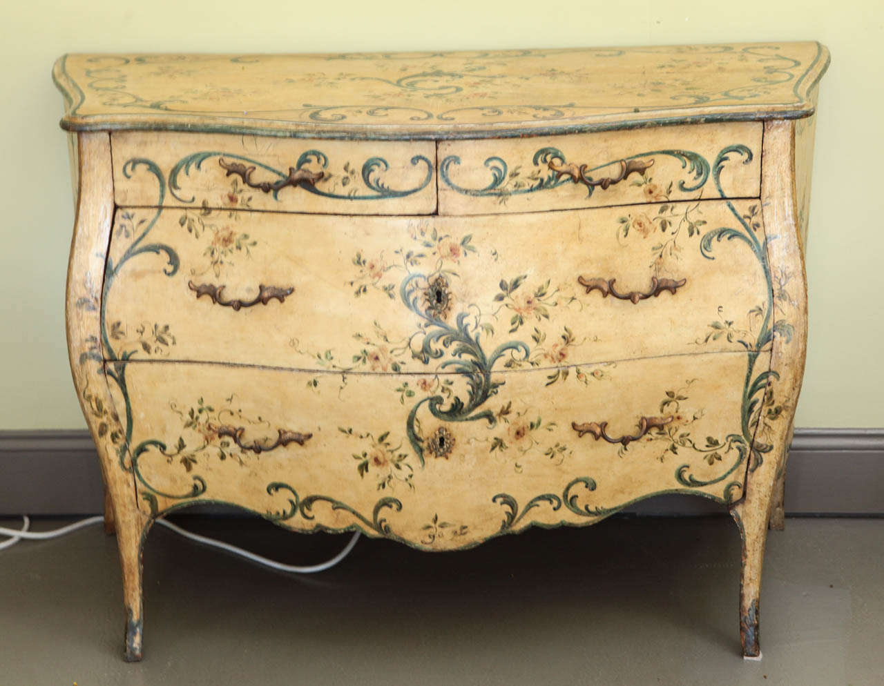 An Italian painted three-drawer commode, early 19th century with later decoration.