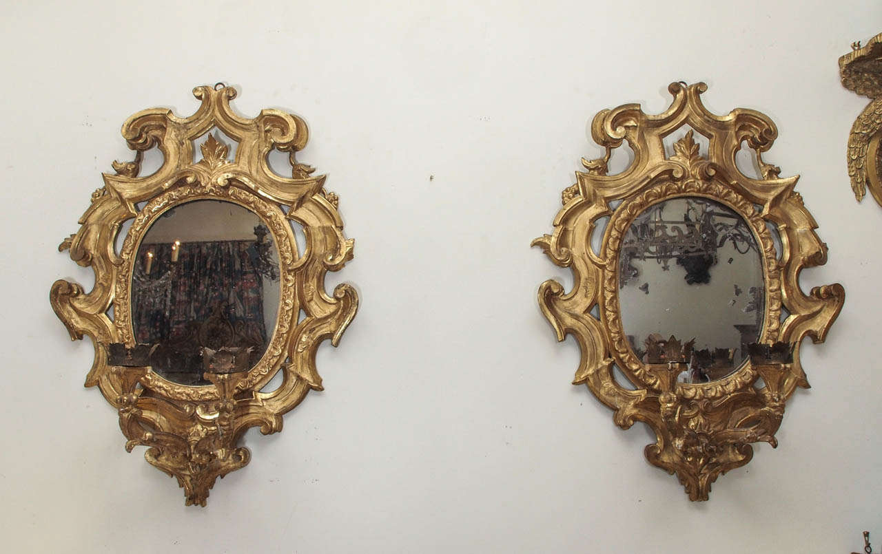 Pair of Italian Baroque style gilt wood mirrors with two candle arms