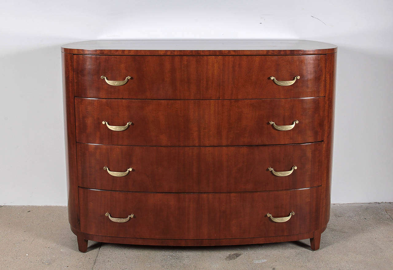 Fantastic 4 drawer bowed front chest of drawers with engraved satin brass pulls. Designed by Ralph Widdicomb.