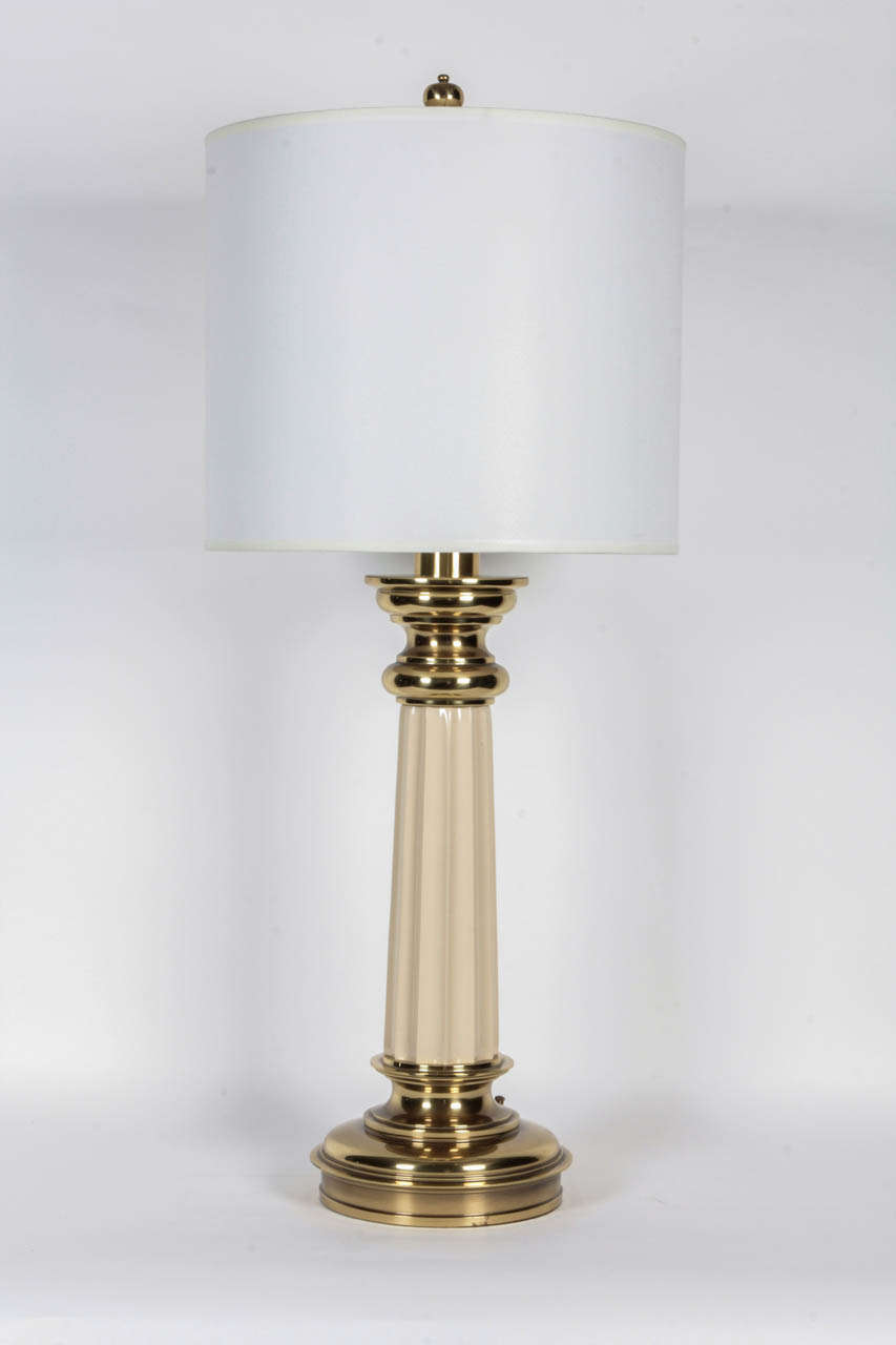 Fantastic pair of Brass and Cream enameled fluted column lamps, Lamps feature new wiring and an on/off switch at the the base.