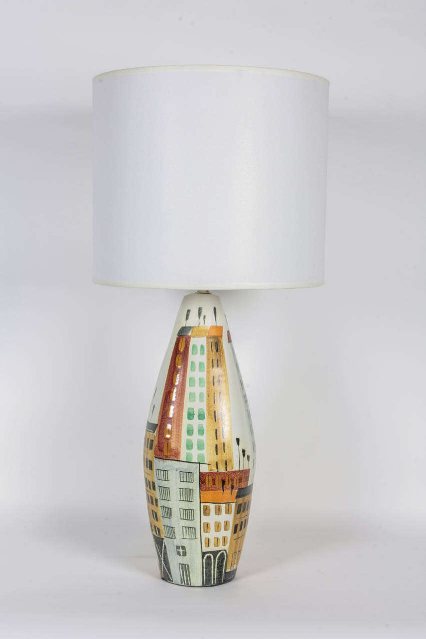 Mid-Century hand-painted ceramic lamps depicting a cityscape. Lamp is decorated on all sides and features new socket and wiring.