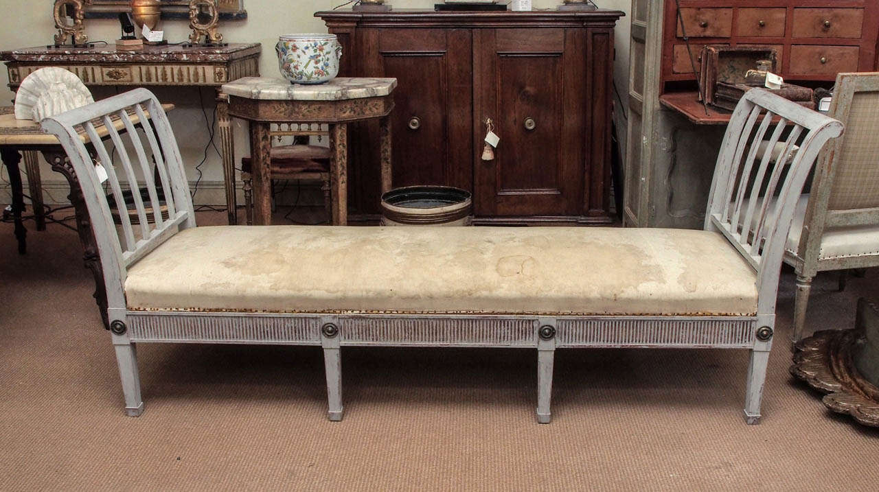 A Swedish painted daybed with brass accents in the Gustavian style.