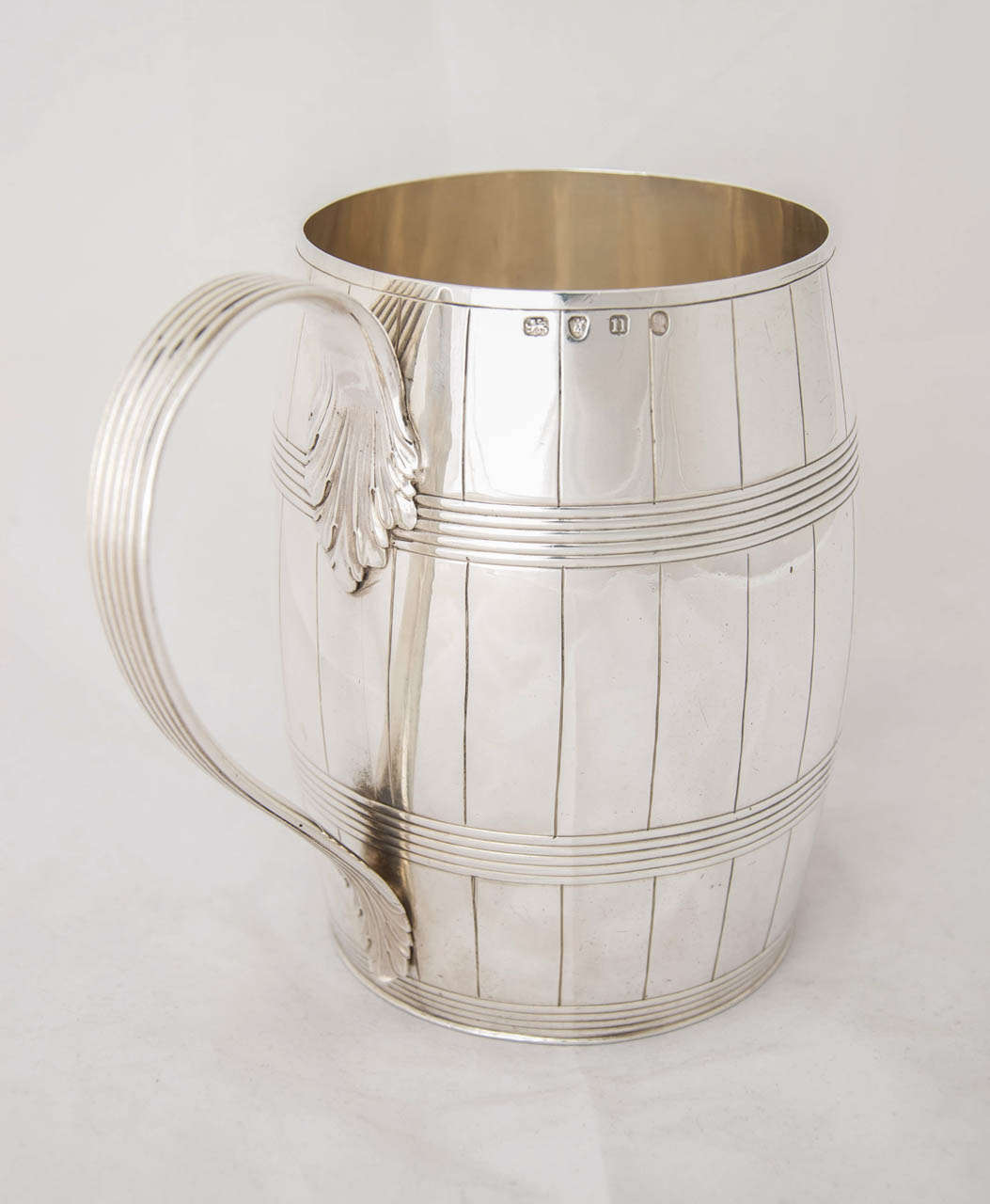 A large antique sterling silver mug or tankard in the form of a barrel, hallmarked in London 1788 and made by Henry Chawner.
Height to top of 