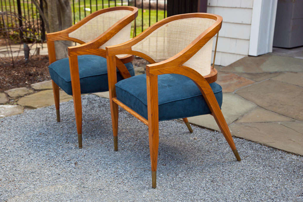 Designed by Edward Wormley for Dunbar Furniture. The chairs are solid ash hardwood with caned backs. They feature brass sabots, and are backed with brass dowels. Priced as a set, can be sold in pairs. Newly upholstered seats.
