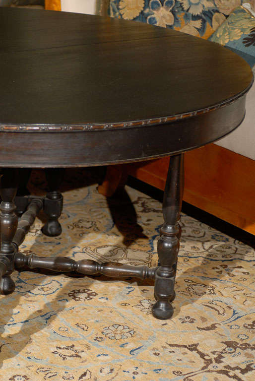 20th Century French Dark Wood Round Dining Table with Five-Leaf Extensions and Turned Legs
