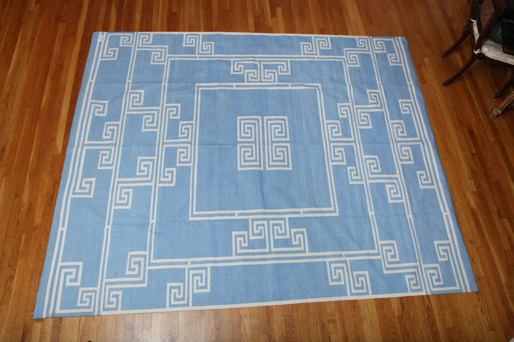 handmade dhurrie carpet with a blue background and white design