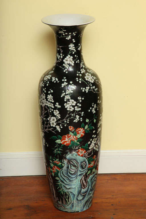 Tall baluster famille noire vase with white prunus decoration and red and white peonies eminating from blue rockwork, on a black ground, Chinese, circa late 19th century. Similar pieces with famille noire decoration are in the Frick Collection, NY
