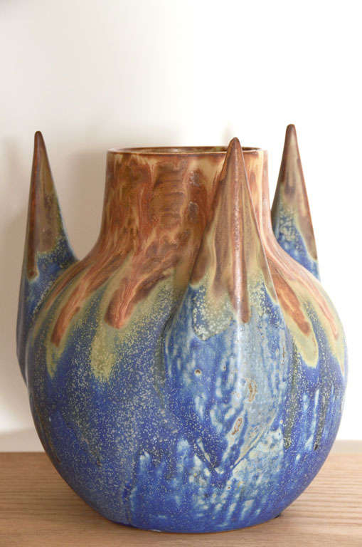 Unique ceramic vase with three prongs - glazing from brown to blue and some shades of green. signed on the bottom.