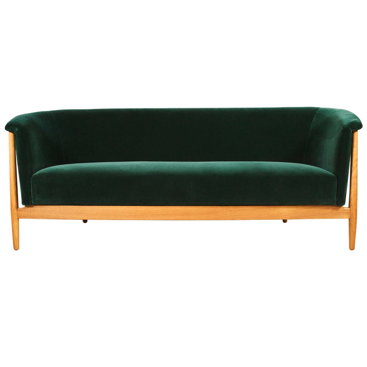 An rare and elegant sofa with rounded corners in oak with a rich natural patina.  Restored in a luxurious emerald green velvet from Holland & Sherry.  A pair of sofa's are available.
Denmark, c.1952