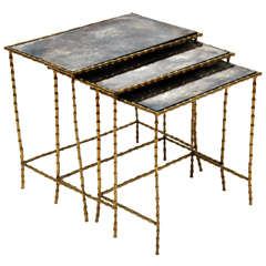 A Chic Set of Three Brass Bamboo and Antiqued Glass Top Nesting Tables