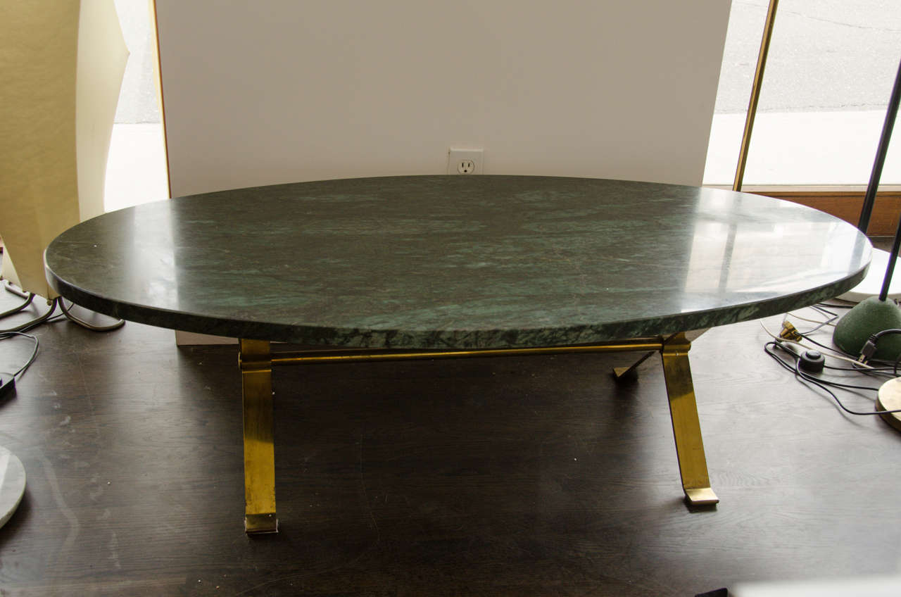 An Oval Green Marble on a Brass Bent Base