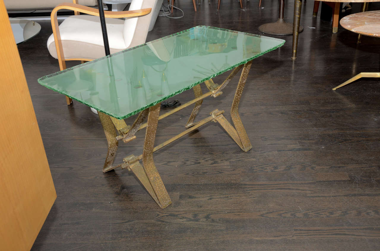 Rare glass coffee tableby Pierluigi Colli.

Edged glass top with etched motifs on bent metal base.