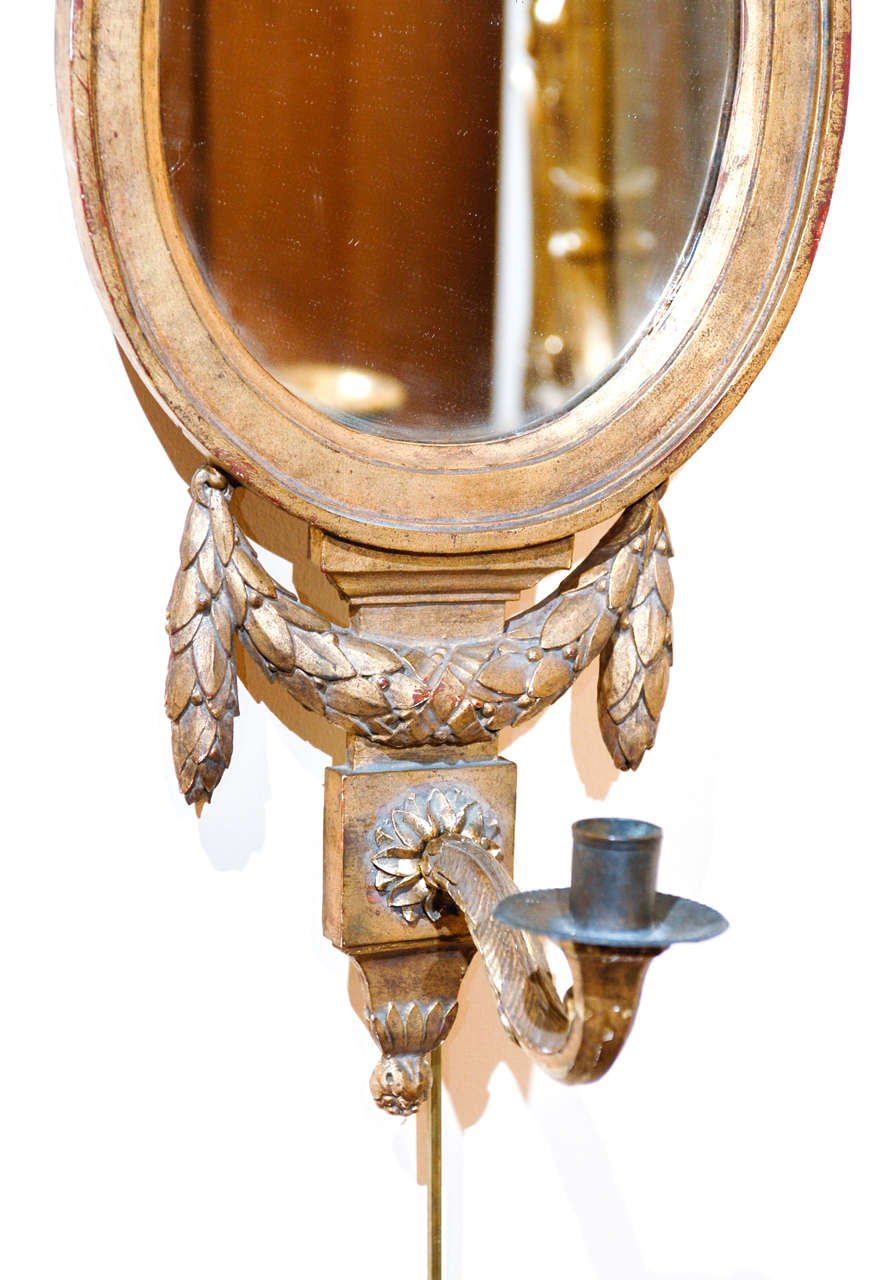 20th Century Pair of Louis XVI Style Gilt-Wood Oval Mirrors with Sconces