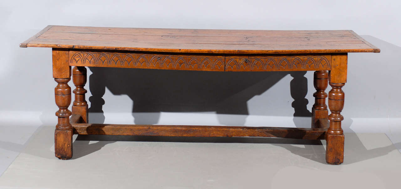 Continental oak farm dining table with carved apron with two drawers, turned legs and stretcher. 

William Word Fine Antiques: Atlanta's source for antique interiors since 1956. 