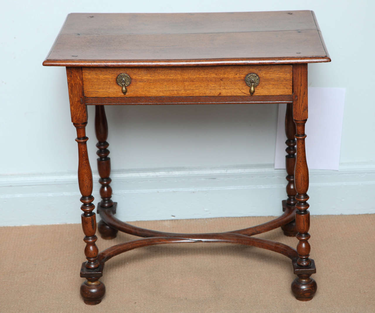 Lovely early 18th century English William and Mary period oak side table, the thumb molded top over single drawer, standing on balustrade turned legs joined by curved 