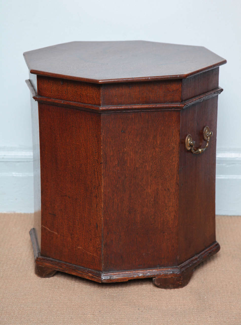 Fine George III octagonal oak lift top box, with molded edge, the sides with original brass handles retaining traces of fire gilding, standing on molded base and plain bracket feet.


