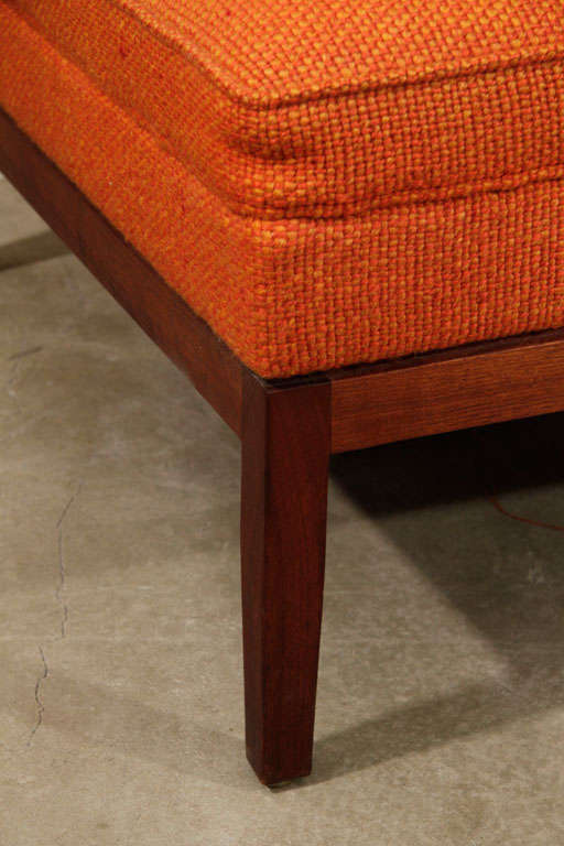 Pair of early Florence Knoll quilted chairs on wood bases.  Fabric is a vibrant nubby orange wool.