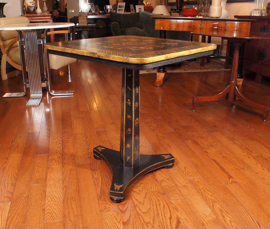 Regency style black painted and gold decorated side table. at 1stdibs