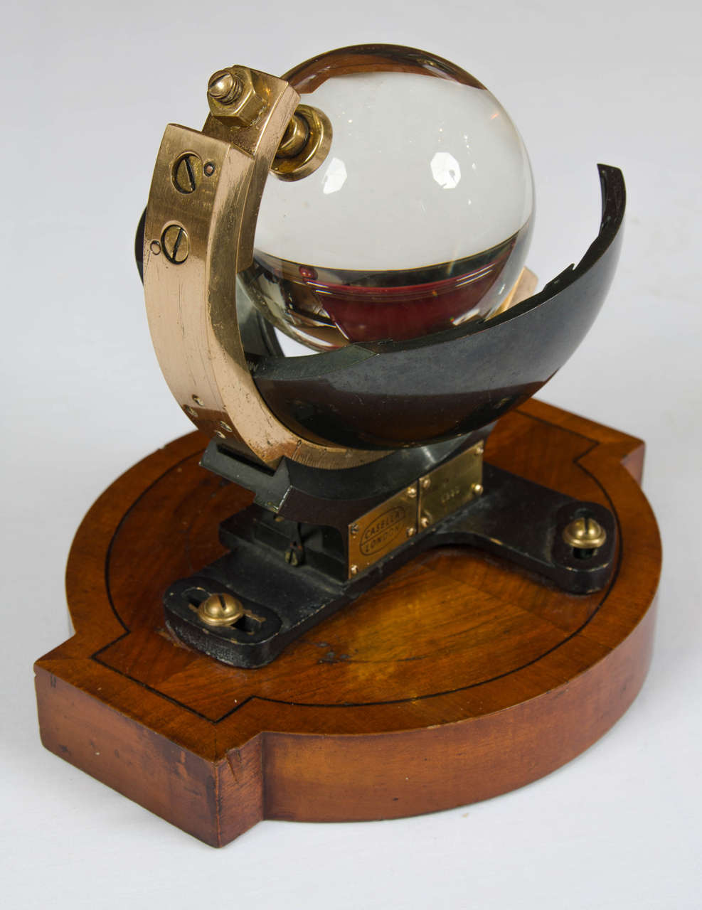 Campbell–Stokes sphere sunshine recorder by Casella of London, mounted on golden oak base, circa 1930. 

Campbell Stokes Sunshine recorder (sometimes called a Stokes sphere) by Casella, London, No.8351. The 4inch glass sphere is mounted in a brass