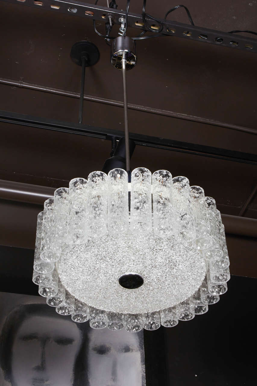 Spectacular pendant fixture composed of 27 individually handblown textured glass cylinders with 