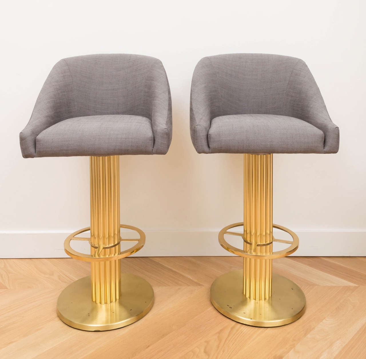 Great pair of Design for Leisure brass stools with a grey linen seat.