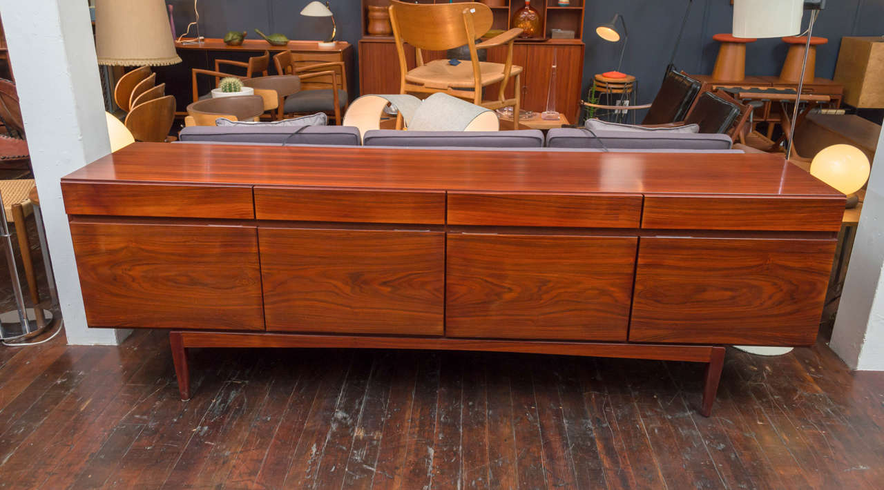 Sunning rosewood credenza designed by Ib Kofod-Larsen, comprising four top drawers over four doors with fitted interiors.
Excellent original condition.