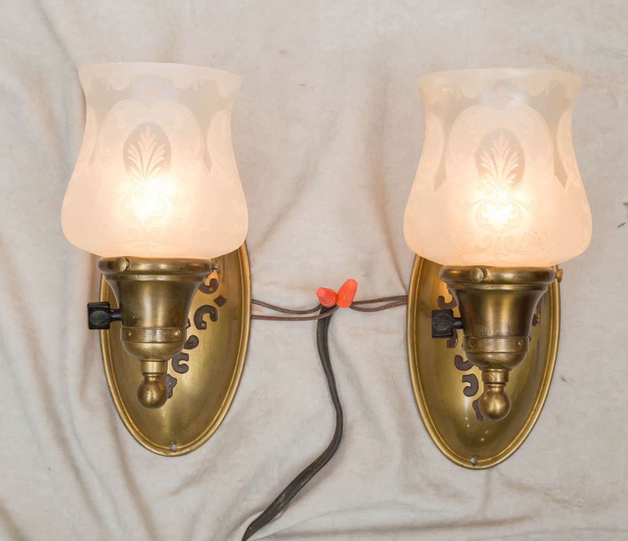These are a nice elegant pair of smaller sconces that could work in many different settings. The gilt bronze finish is original, and does have some wear areas that we felt were not so distracting as to redo all the metal work. These are antiques,