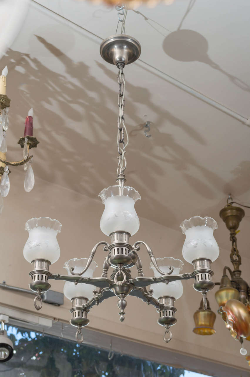 This very high quality chandelier is a little different from what we normally carry. We were overtaken by the condition and quality. When taken apart, all the parts were numbered, as we only find on the best of our lighting. The finish is