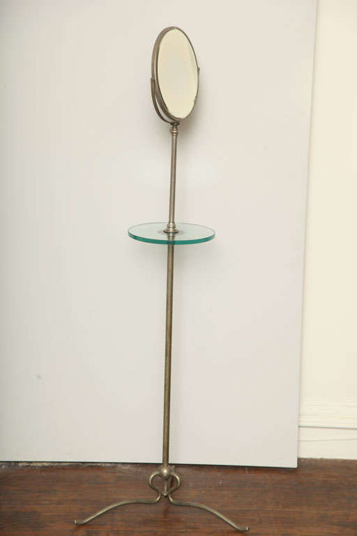 Tall shaving mirror with glass shelf and adjustable height.  Mirror is reversible with magnifying feature