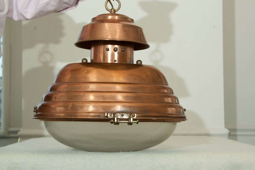 ALL COPPER  HANGING CHANDELIER  TYPE LIGHT THAT  WAS ONCE USED AS A LIGHT TO ILLUMINATE  CHARTS. SHAPED GLASS AT  BOTTOM.  CONVERTED FROM OIL  TO ELECTRIC