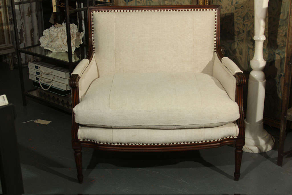 Wood frame reupholstered in linen with down cushion and nailhead trim.