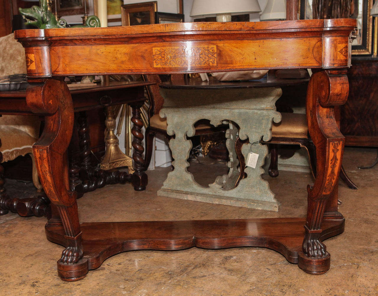 Handsome, hand-carved, claw foot, florentine console table with inlaid, serpentine top.