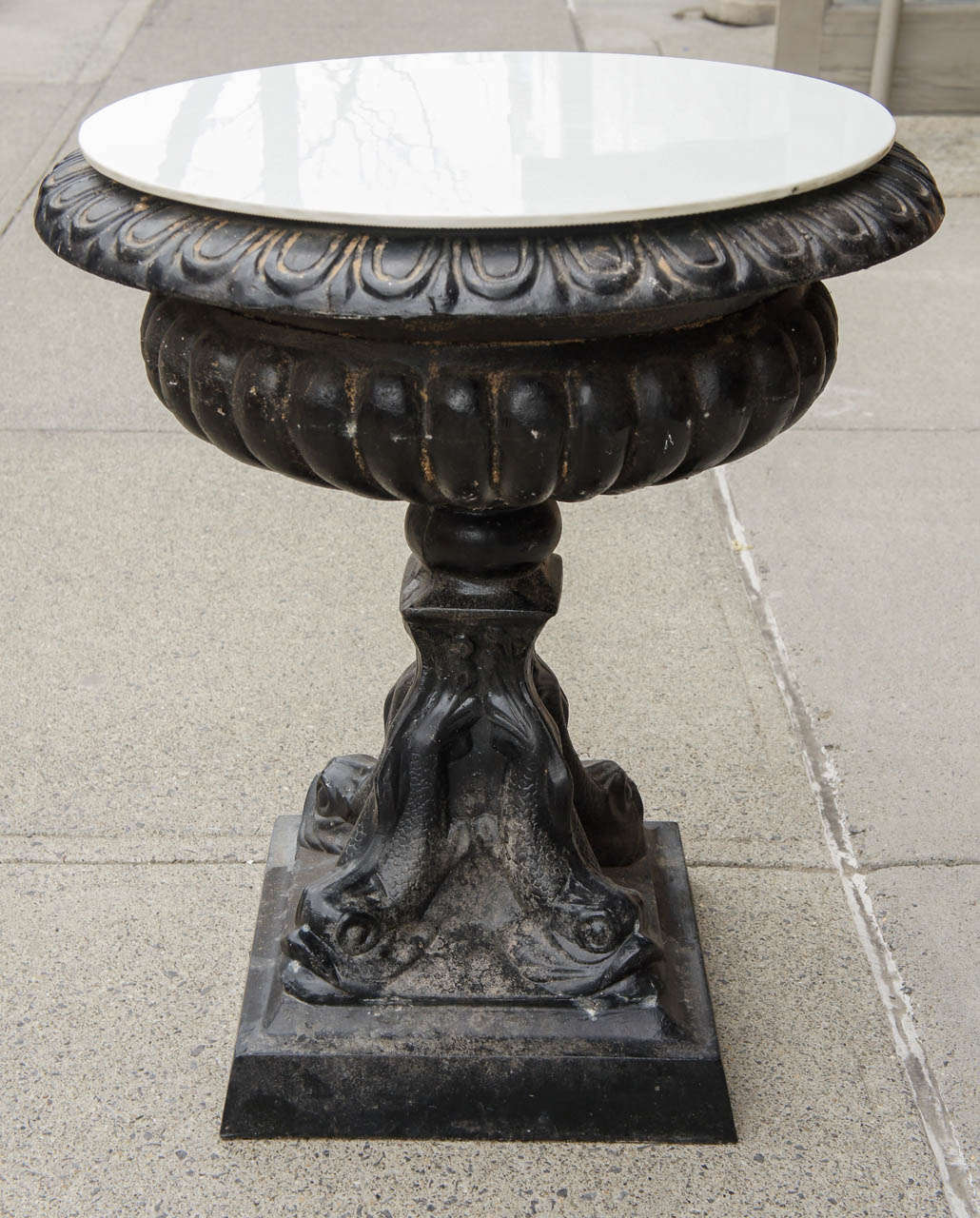 This nice old vintage urn table is both usable as an urn as the glass top lifts off or as a table. Purchased between a set of sofas used out side this table comes with a white vermiculite glass top conforming to a large egg & dart deep border. The