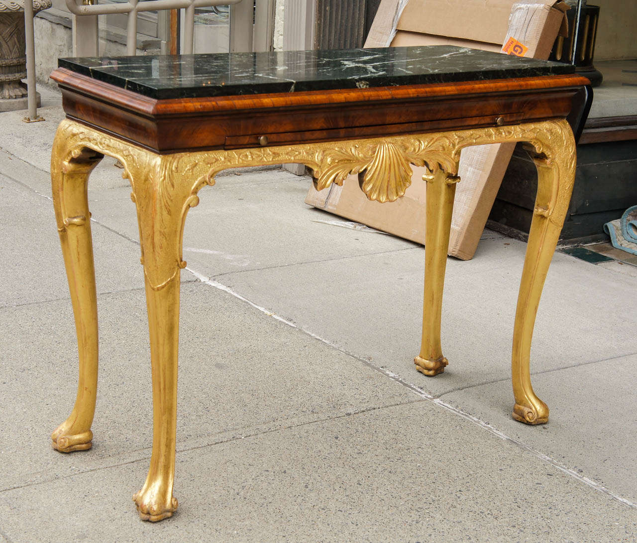 This table made in the Queen Anne style in England Circa 1860 was probably made as a companion piece to match an original table of the period creating a pair for a large stately home. No expense was spared at the time to achieve a rich and lustrous