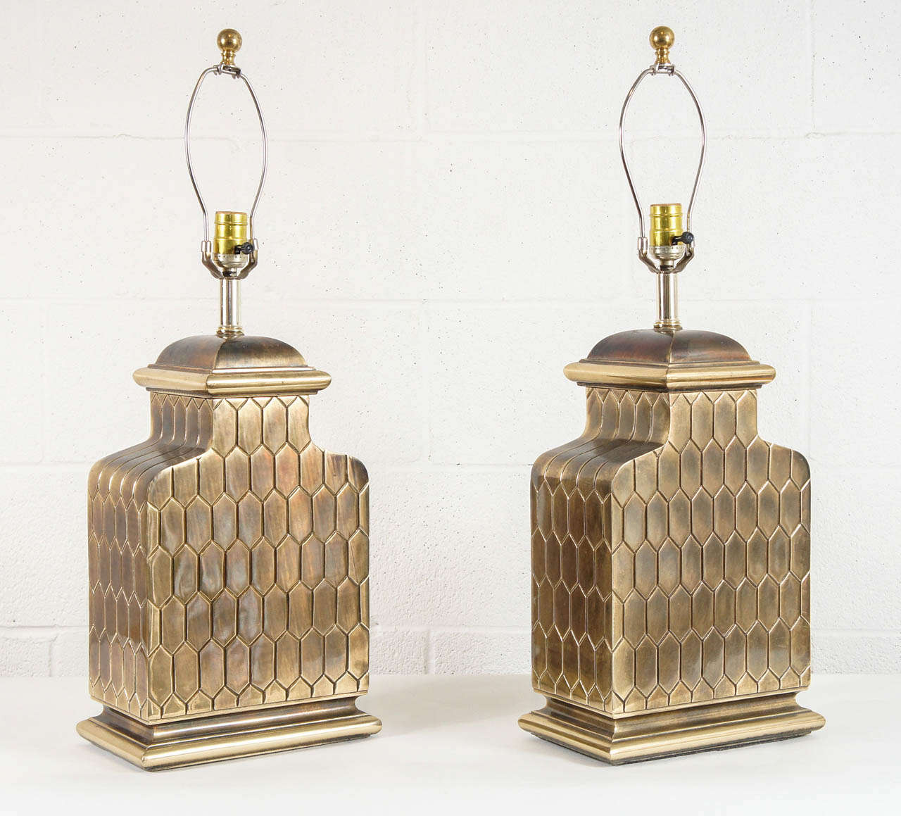 Here is a beautiful pair of brass lamps with fish scale detail.