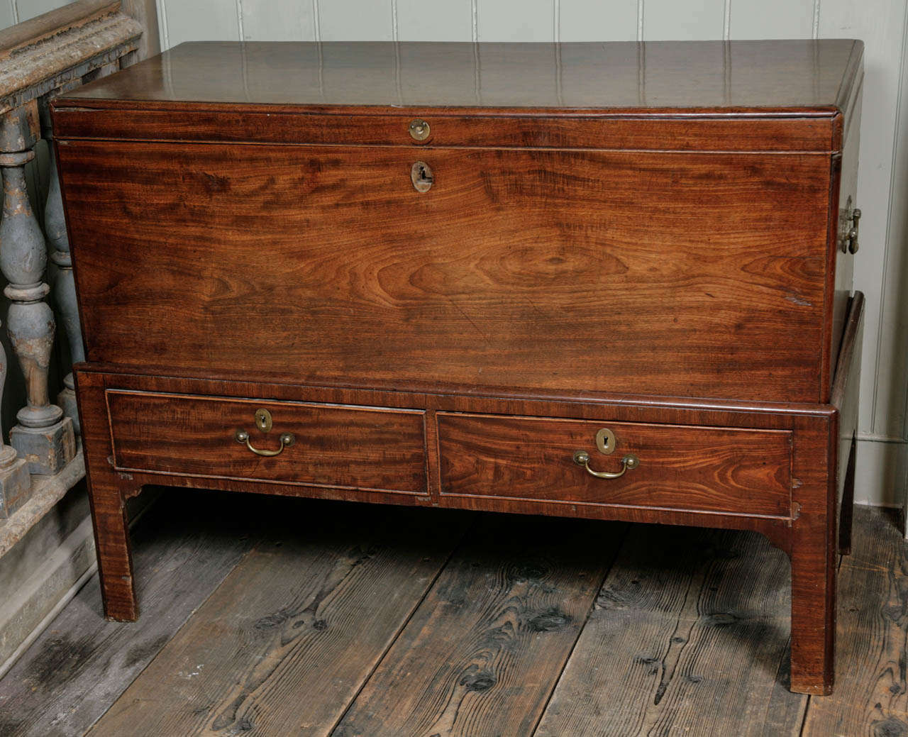 with exceptional timber having a hinged lid above two frieze drawers on squared chamfered legs. English, c. 1740