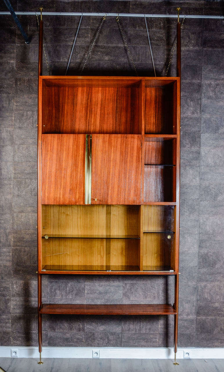 Italian rosewood single bookcase and shelving with brass details. Adjustable metal feet.